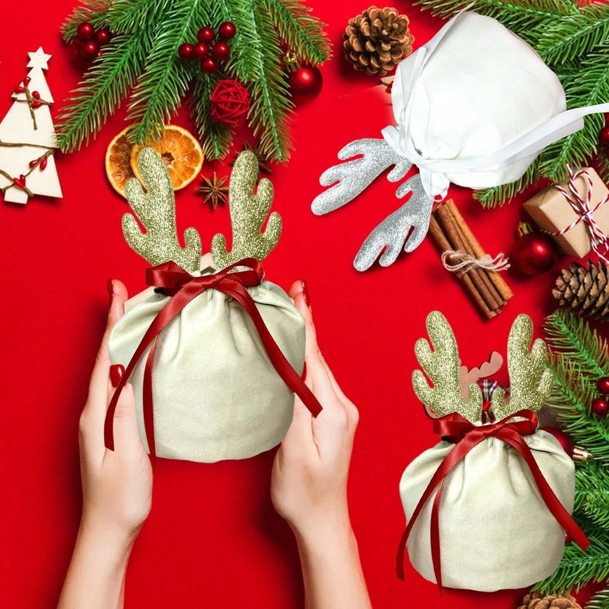 Christmas velvet drawstring gift pouches with glitter reindeer antlers and red ribbons on red festive background