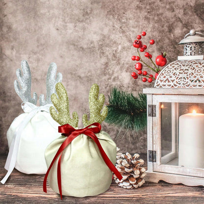 Christmas velvet drawstring gift pouches with glitter antlers, red ribbon, pinecone, and candle lantern