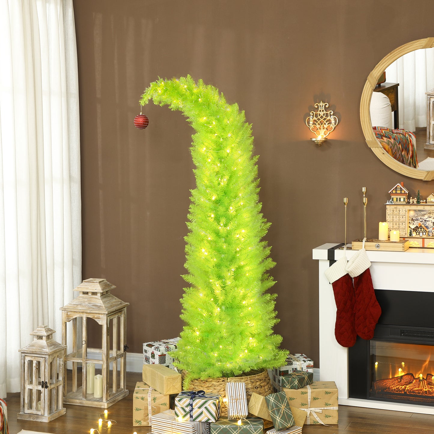 Bright green whimsical Christmas tree with lights and one red ornament, surrounded by gifts in cozy living room