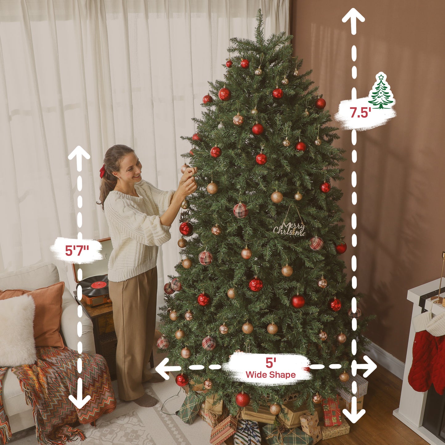 Woman decorating 7.5 ft wide Christmas tree with red and gold ornaments in cozy living room