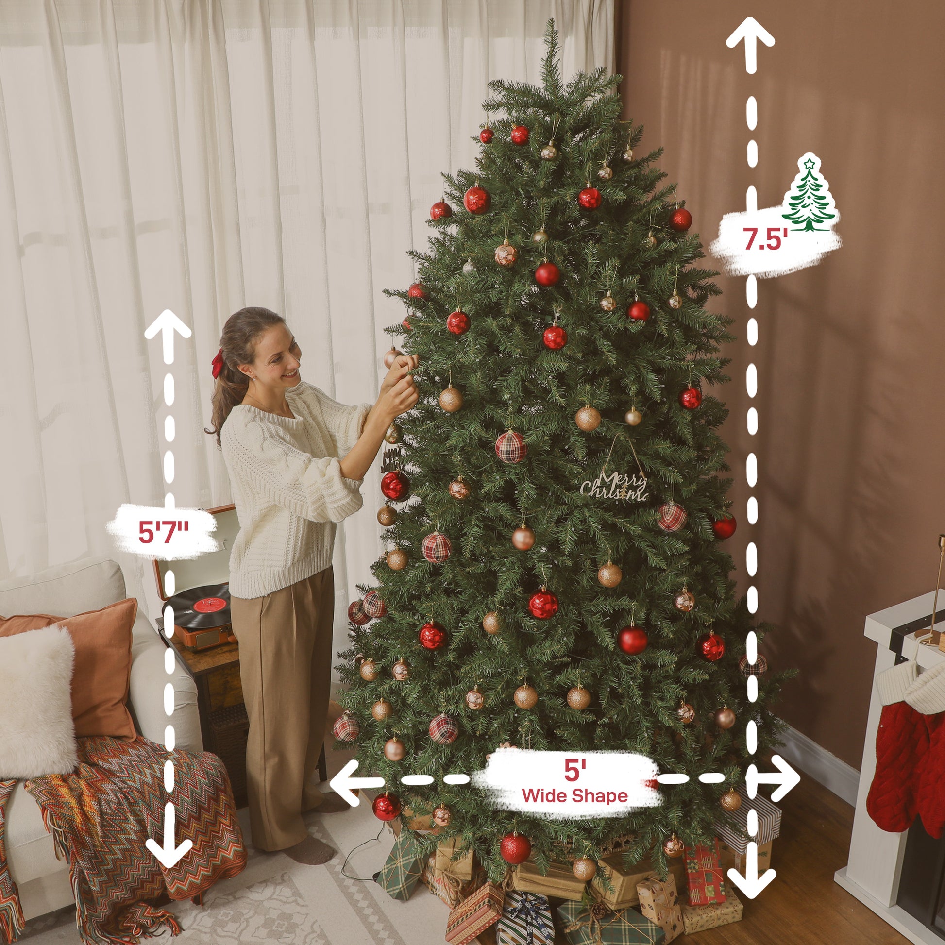 Woman decorating 7.5 ft wide Christmas tree with red and gold ornaments in cozy living room