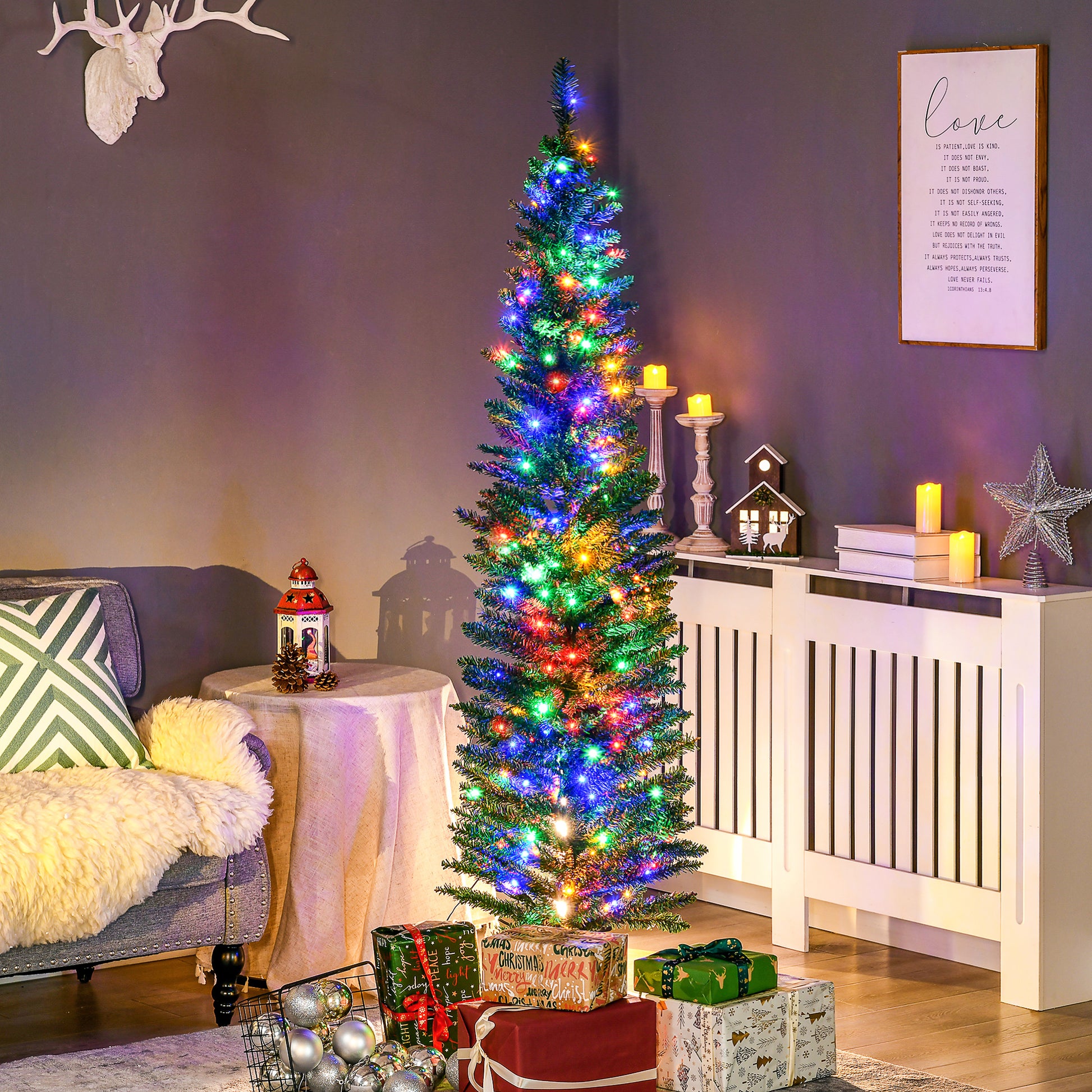 Slim artificial Christmas tree with multi-color LED lights in cozy living room with gifts and holiday decor