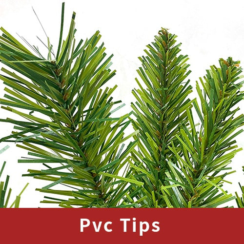 Close-up of green PVC artificial Christmas tree tips with dense needles on white background