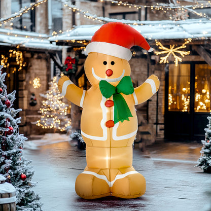 Inflatable Christmas gingerbread man with red Santa hat, green bow, standing on snowy decorated street with lights