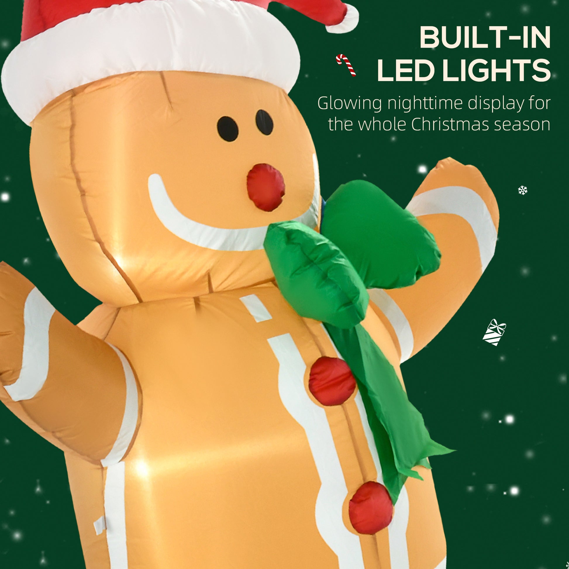 Inflatable gingerbread man Christmas decoration with built-in LED lights and green scarf on dark background