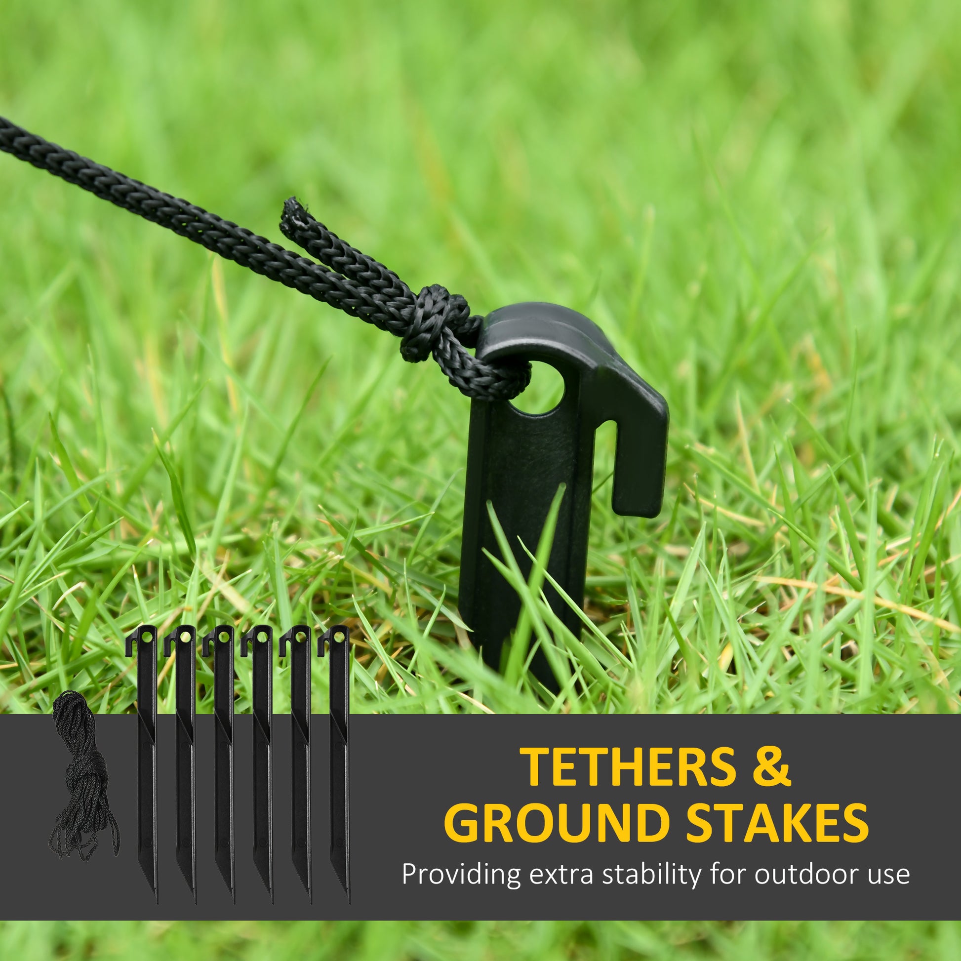 Black ground stake with tether rope secured in green grass for outdoor stability