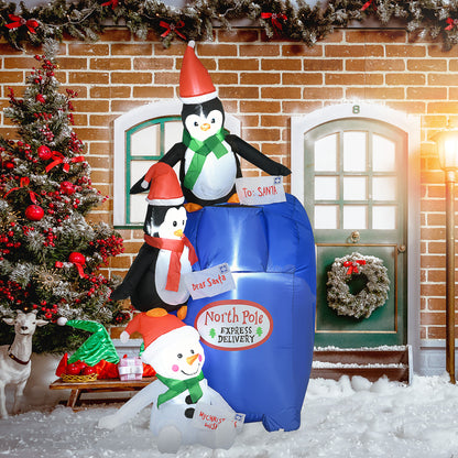Christmas inflatable mailbox with penguins and snowman holding letters in snowy festive yard