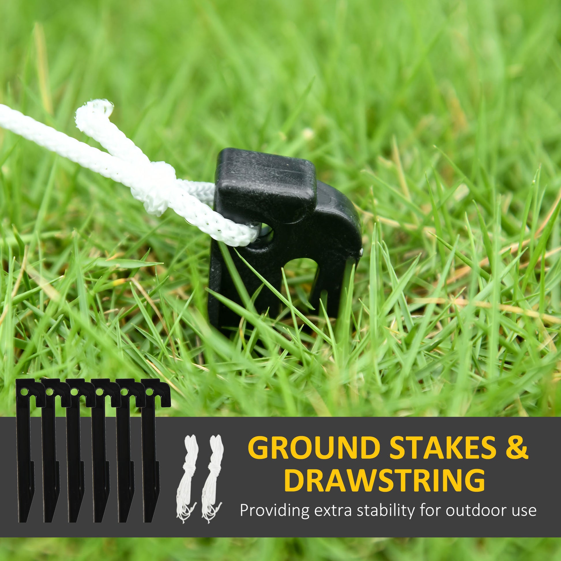 Black plastic ground stake with white drawstring tied on green grass for outdoor stability