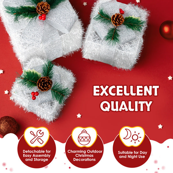 Set of three silver lighted gift boxes with pinecone and greenery decorations on red background