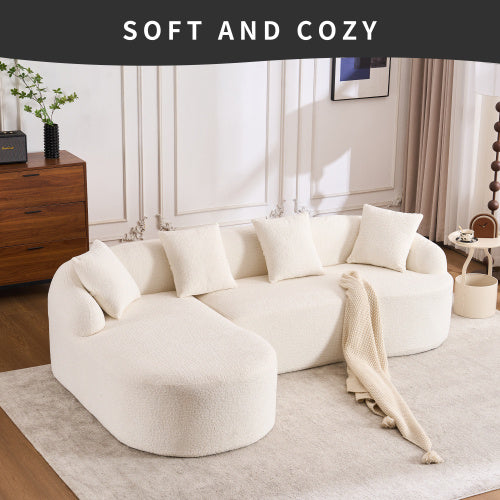 Curved white plush sofa with cushions in modern living room featuring wooden cabinet and soft rug