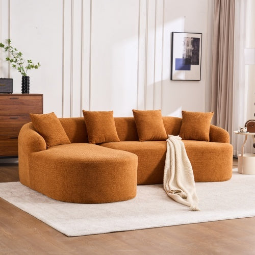Orange L-shaped modular sectional sofa with chaise, five cushions, and cream throw in modern living room