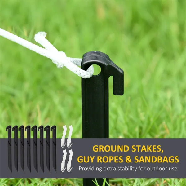 Black ground stake with white guy rope tied, used for outdoor stability on grass