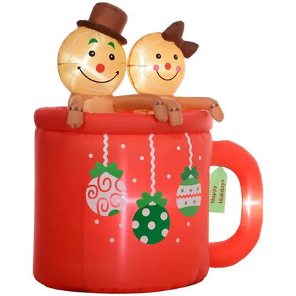 Inflatable Christmas yard decor of two gingerbread figures in a red hot cocoa mug with holiday ornaments