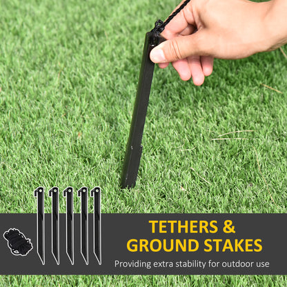 Hand inserting black ground stake into green grass, with image of five stakes and rope, outdoor tether stability