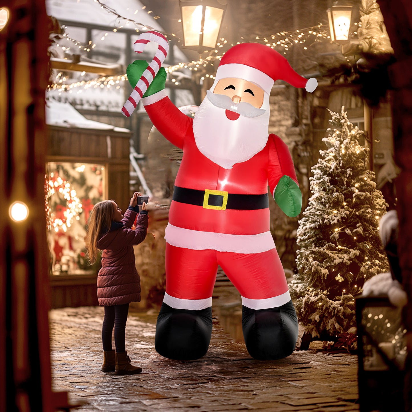 8ft inflatable Santa Claus decoration holding candy cane on snowy cobblestone street with Christmas lights