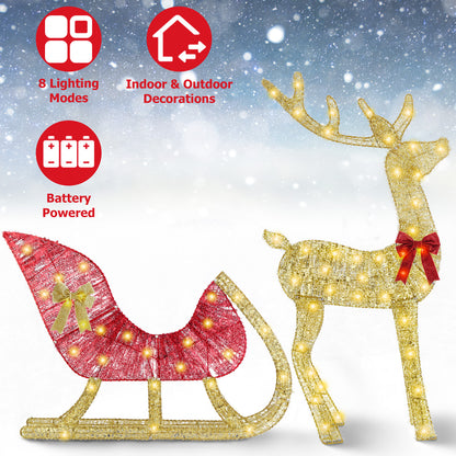 Lighted Christmas reindeer with red bow and red sleigh decorated with gold bow, battery powered