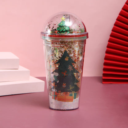 Christmas-themed water cup with 3D Christmas tree figurine under dome lid and star glitter