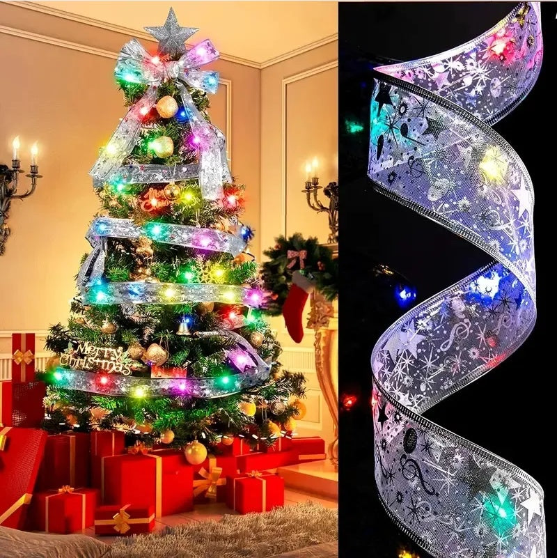 Decorated Christmas tree with silver mesh ribbon, colorful lights, gold ornaments, star topper, and red gift boxes