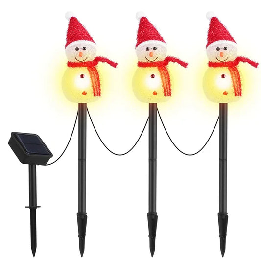 Set of three solar-powered snowman stake lights with red hats and scarves glowing warm white