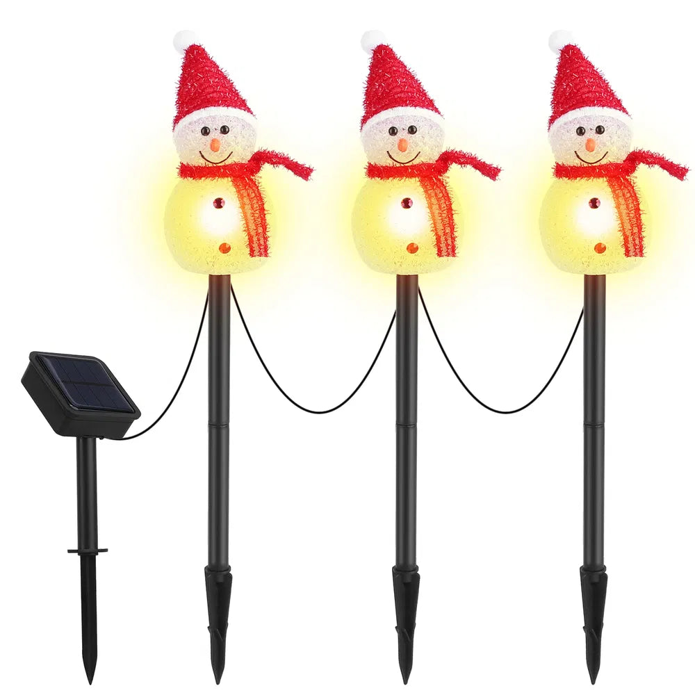 Set of three solar-powered LED snowman stake lights with red hats and scarves
