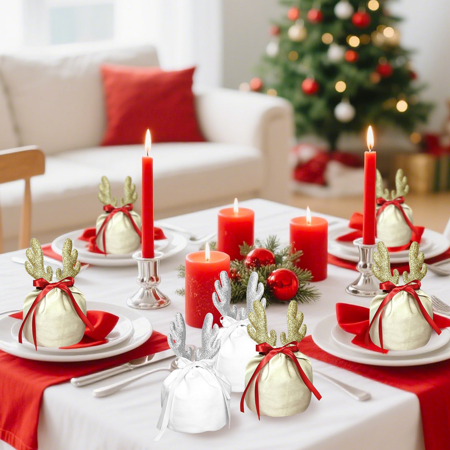 Christmas dining table with red candles and fabric gift bags decorated with golden and silver reindeer antlers
