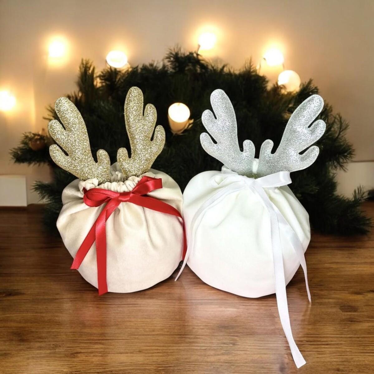 Christmas gift bags in khaki and white fabric with glittery reindeer antler decorations and ribbon bows