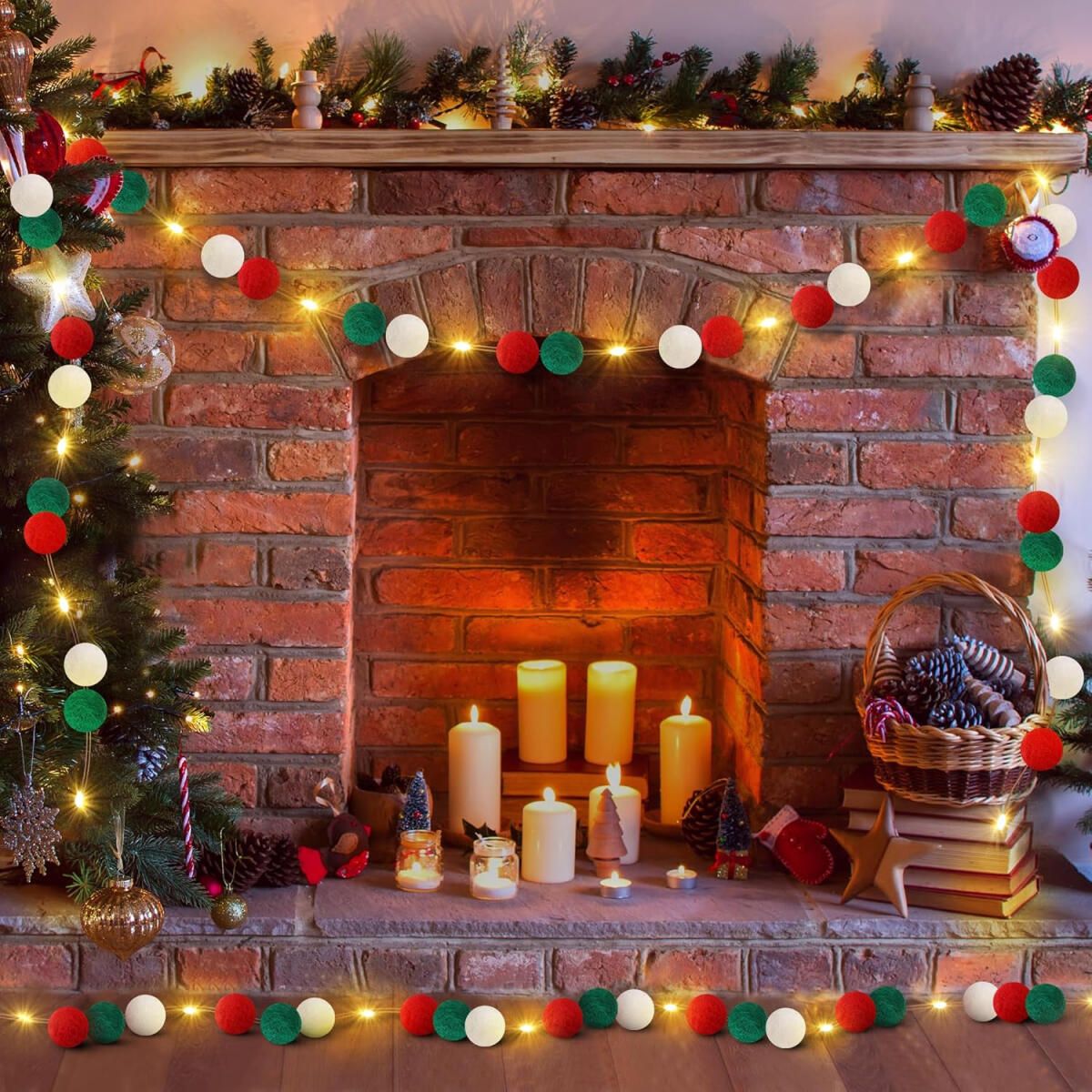Cozy brick fireplace decorated with red, green, white felt ball garland and lit candles for Christmas