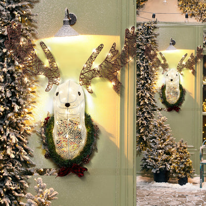Lighted white reindeer head wall decor with warm white LED lights, wreath, and snowy Christmas trees