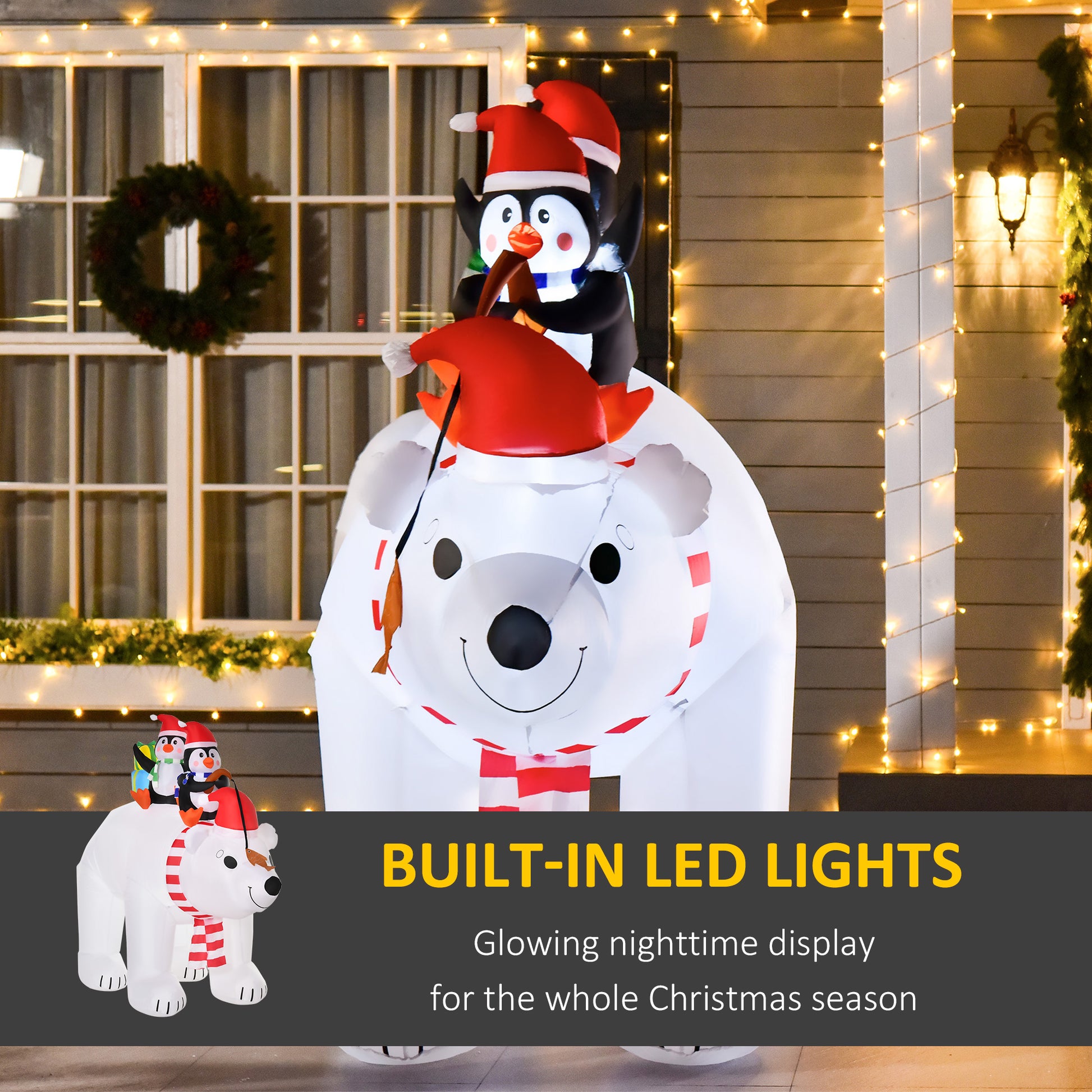 Inflatable Christmas decoration of a smiling polar bear wearing a scarf and Santa hat, with two penguins in Santa hats on its back, lit by built-in LED lights outside a house