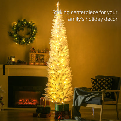 White pencil Christmas tree with warm white LED lights by a fireplace, decorated holiday wreath and cozy armchair