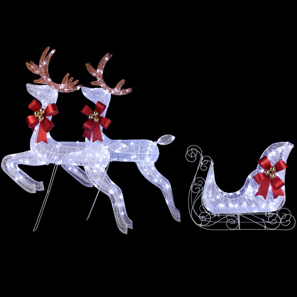 White LED lighted Christmas yard decor featuring two reindeer with red bows and a sleigh