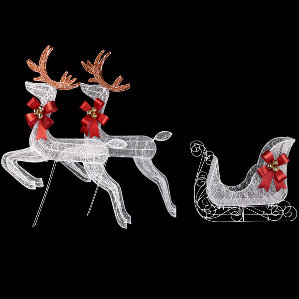White LED Christmas yard decor featuring two reindeer with red bows and gold bells and a matching sleigh on black background