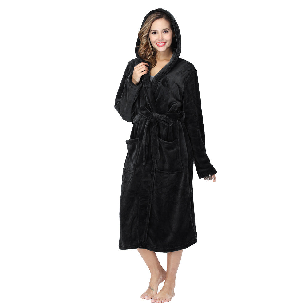 Smiling woman wearing black plush fleece hooded robe with pockets and belt on white background